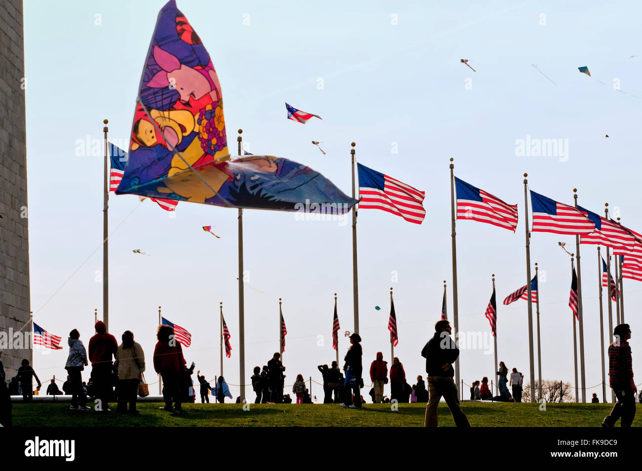 People flying kites on the Washington Monument grounds during the National Kite Festival. Stock Photo