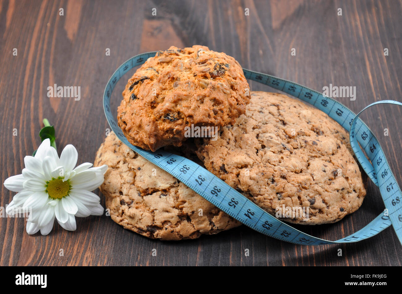Three cookies with cereals on a wooden background Stock Photo