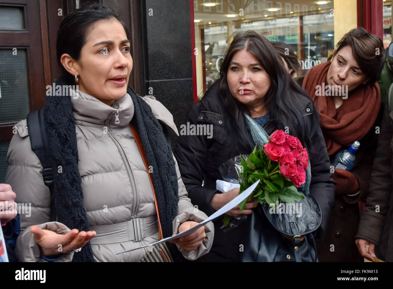 London, UK. 7th March, 2016. One of the two who went in to take a letter to the Honduran Charge d'Affaires calling for an international inquiry into the murder of environmental activist Berta Cáceres, leader of the Civic Council of Popular and Indigenous Organisations of Honduras (COPINH) in her home on March 3 reports back to the people at the vigil on the pavement outside. Peter Marshall/Alamy Live News Stock Photo