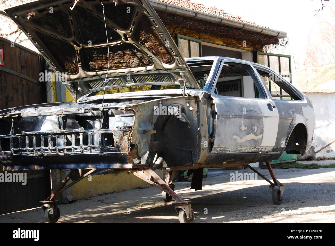Old car chassis in preparation for painting Stock Photo Alamy