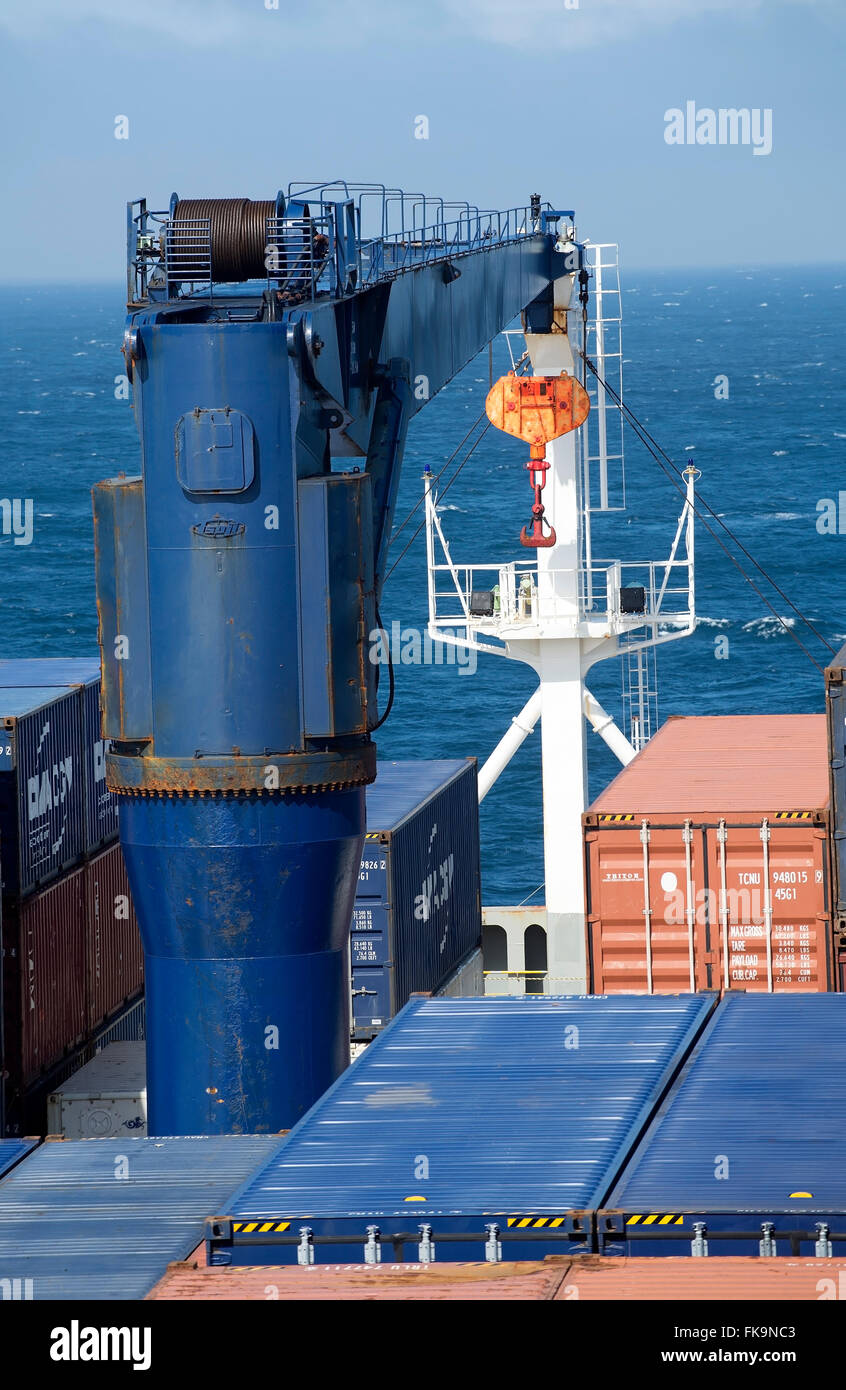 View of containers, crane, and mast of Utrillo container ship in the South Pacific Ocean from high up on the bridge. Stock Photo