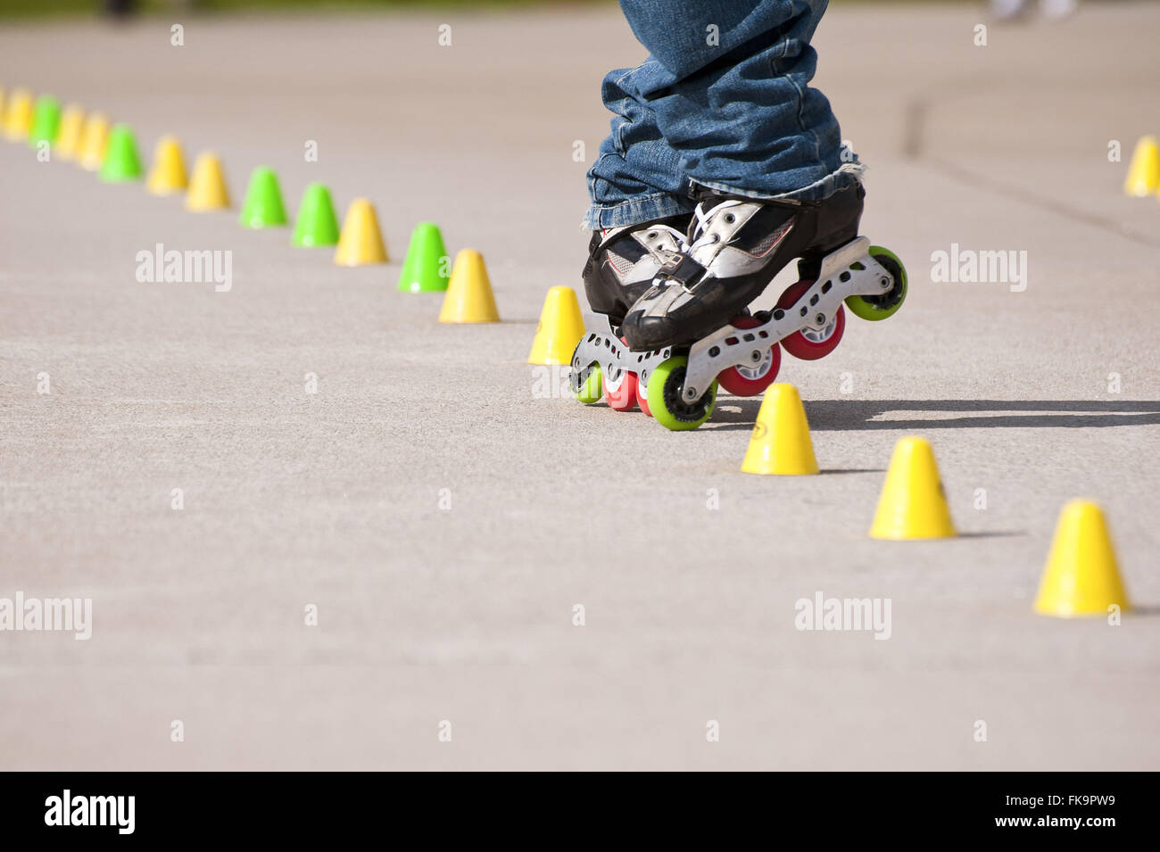 Skater dodging obstacles on the ground in park Stock Photo