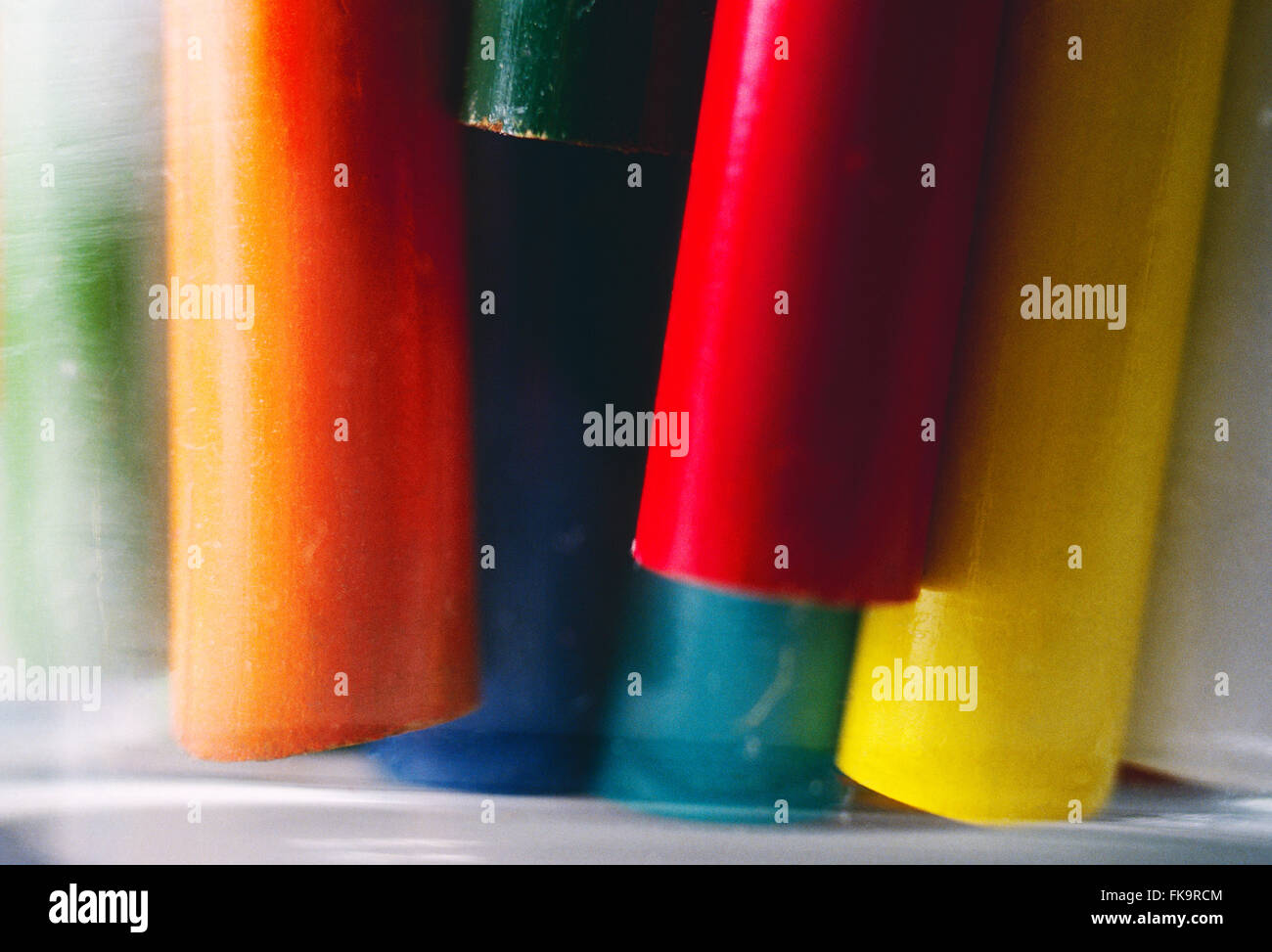 Close-up of colorful drawing pencils in a glass jar Stock Photo