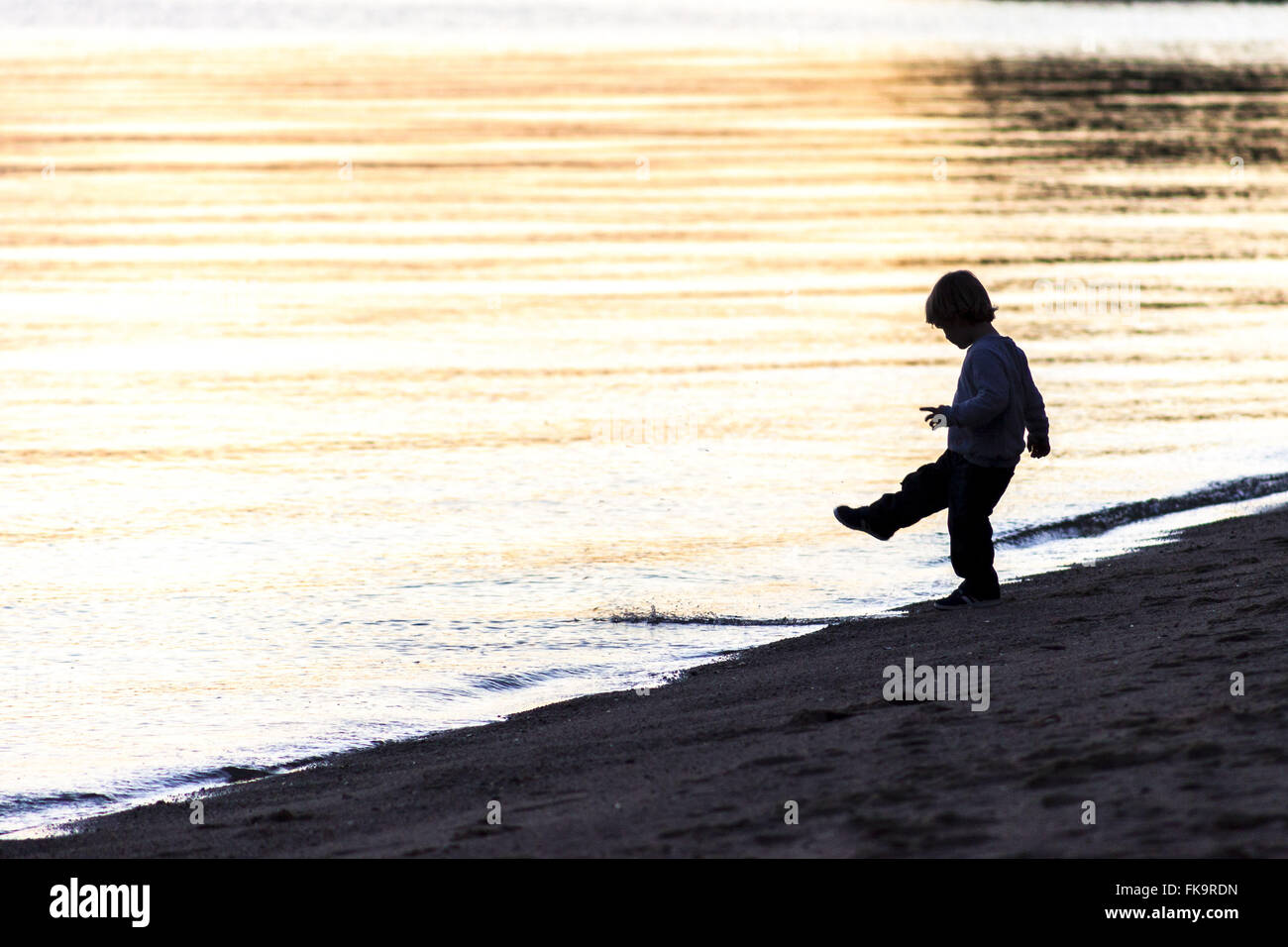 Boy playing on the sea beach in the district of Santo Antonio de Lisboa Stock Photo