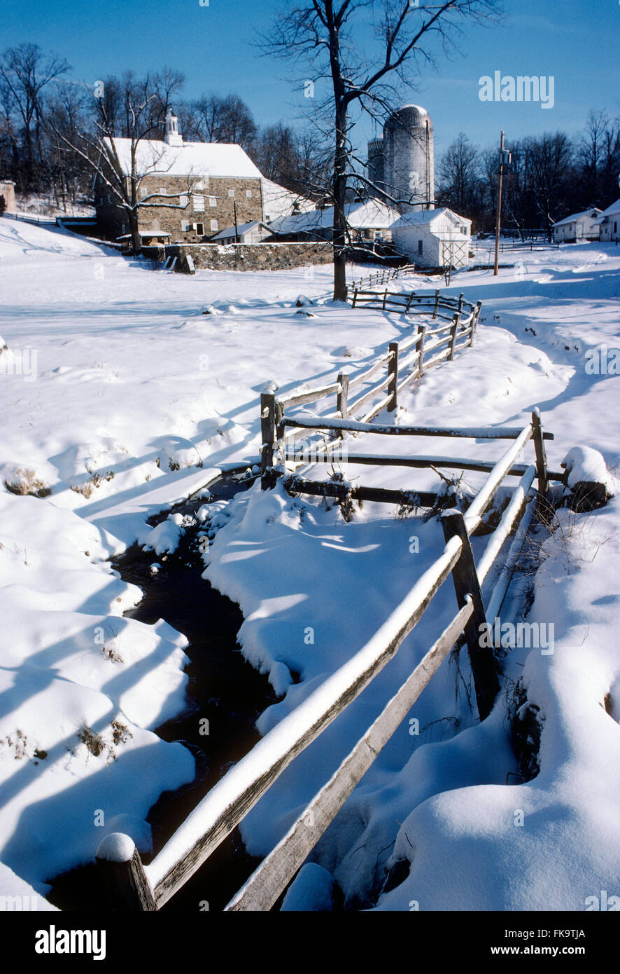 Fresh winter snow on old stone barn; fence; farm; Montgomery Country; Pennsylvania; USA Stock Photo