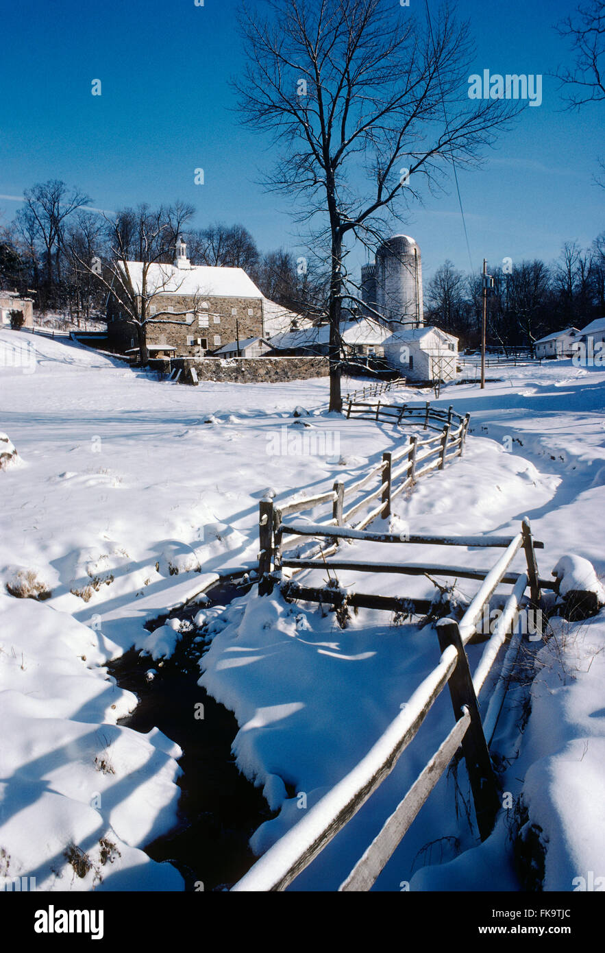 Fresh winter snow on old stone barn; fence; farm; Montgomery Country; Pennsylvania; USA Stock Photo