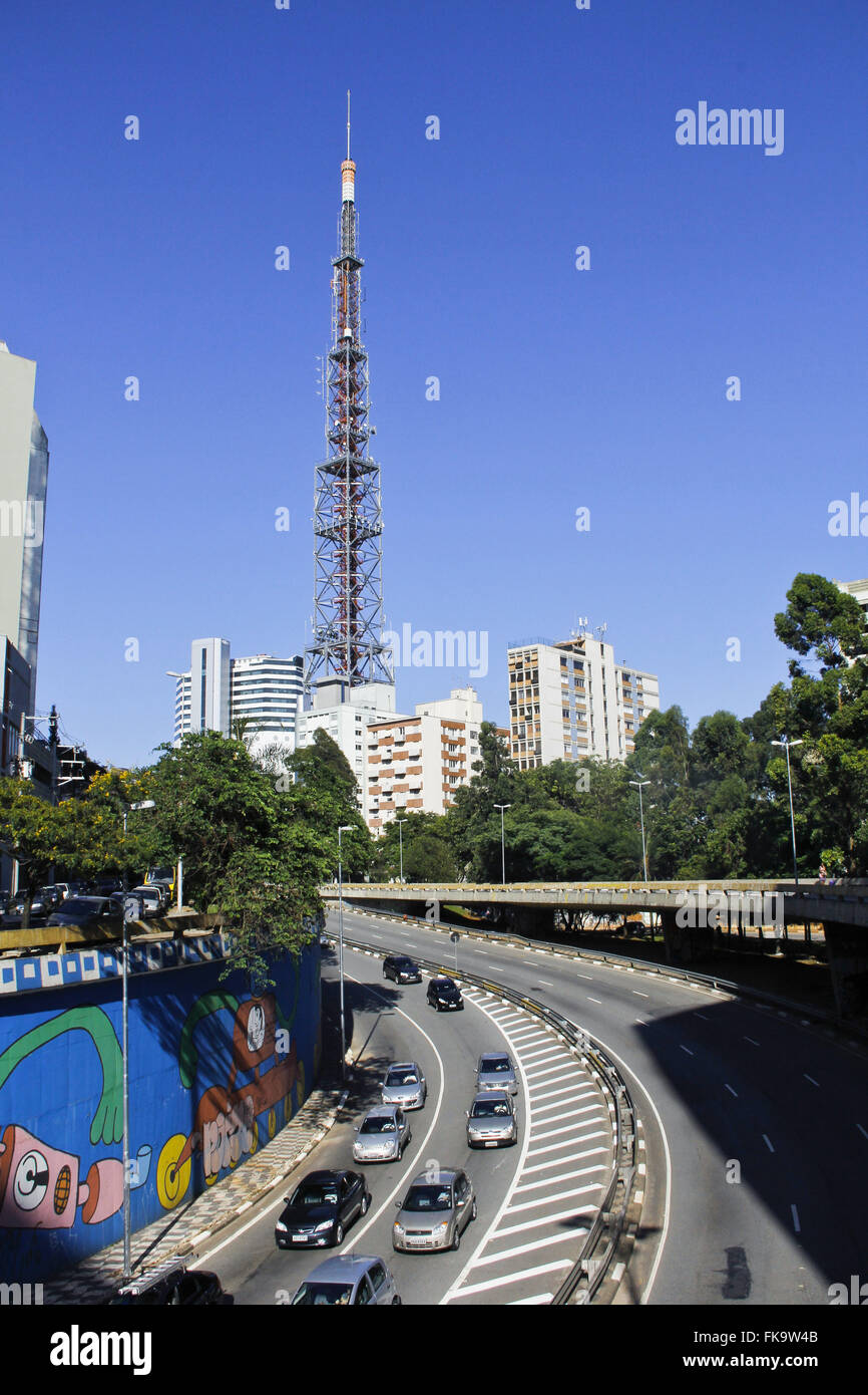 Tower of transmission and vehicle traffic on Avenue Stock Photo