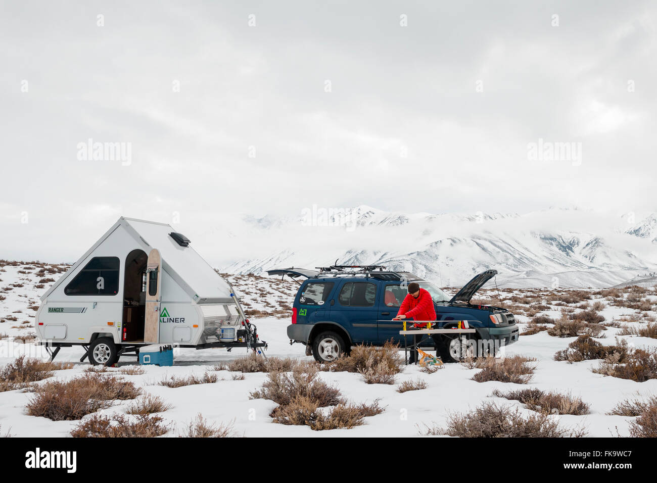 Rustic Winter Camping Near Mammoth Mountain Waxing Skis In The Desert Outdoors With Small Aliner Trailer Stock Photo Alamy