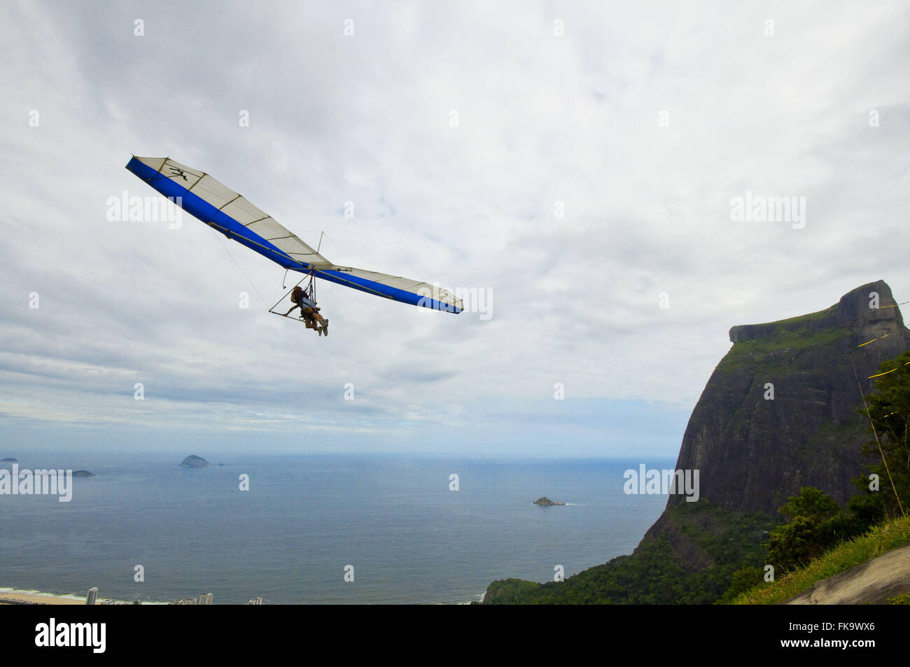 Hang glider flying over the Pedra da Gávea in Tijuca National Park Stock Photo