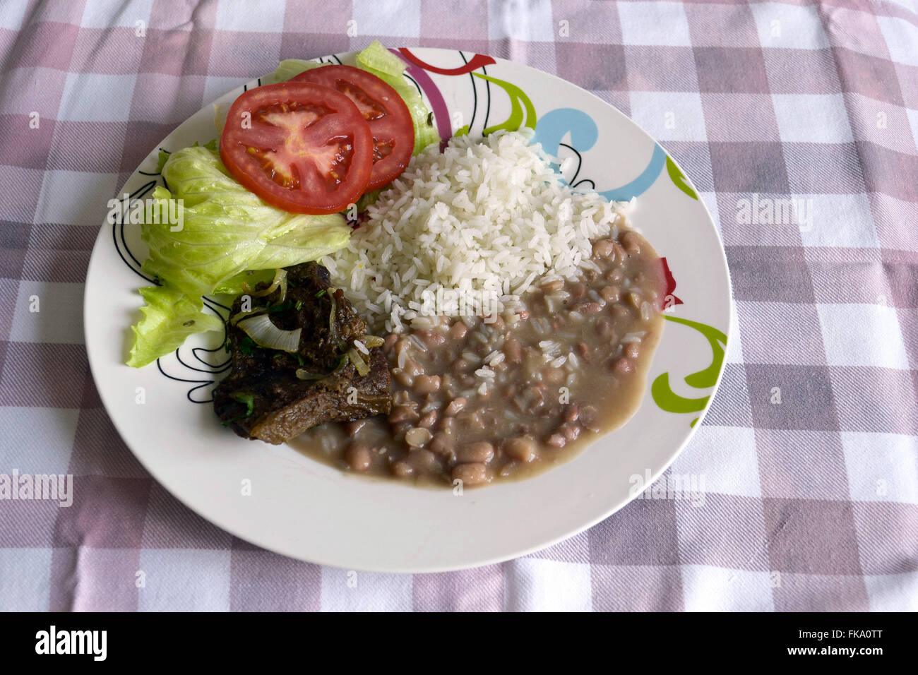 Plate of rice, beans, meat and salad Stock Photo