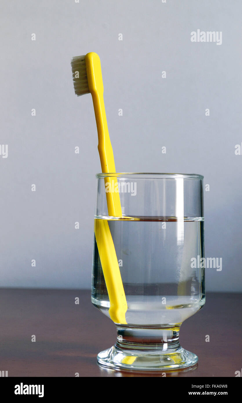 Toothbrush in glass of water - refraction phenomenon Stock Photo
