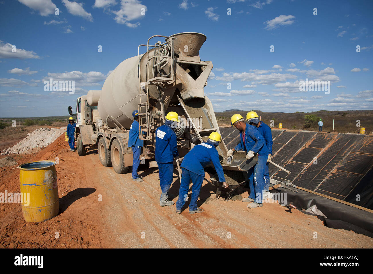 Concrete mixer unloading concrete channel in the Sao Francisco river
