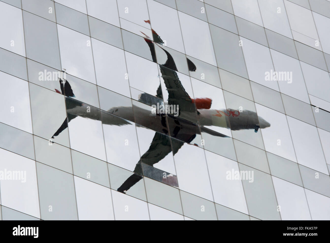 Reflection of plane in glass facade commercial building in New Faria Lima Stock Photo