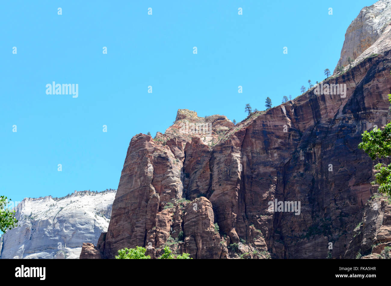 Scenic view of tall mountains under blue sky in Zion National Park, Utah. Stock Photo
