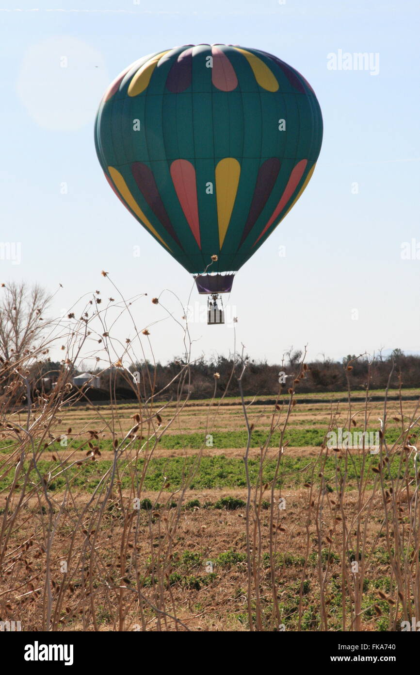 Hot air balloon landing in field southern nevada desert Stock Photo