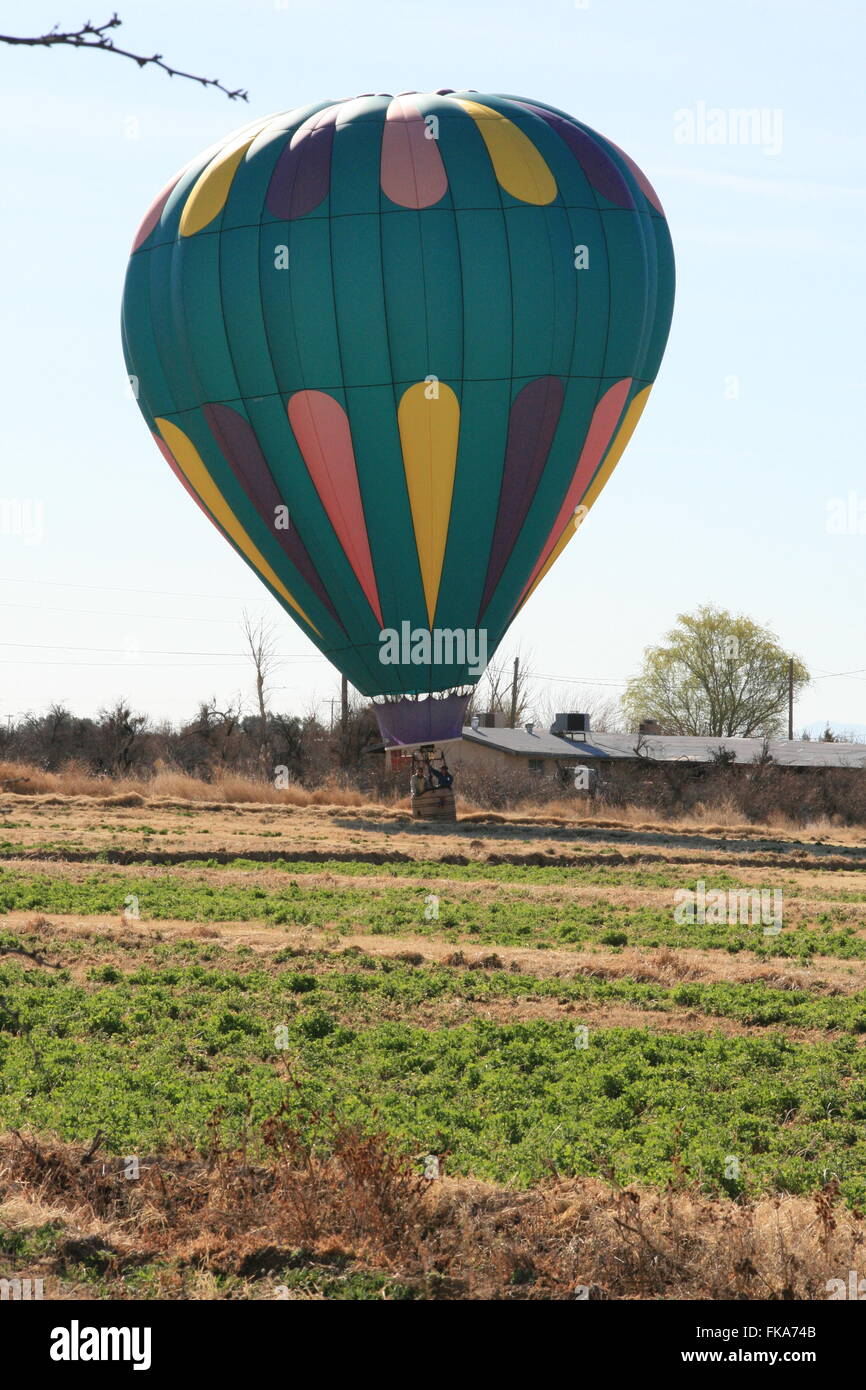 Hot air balloon landing in field southern nevada desert Stock Photo
