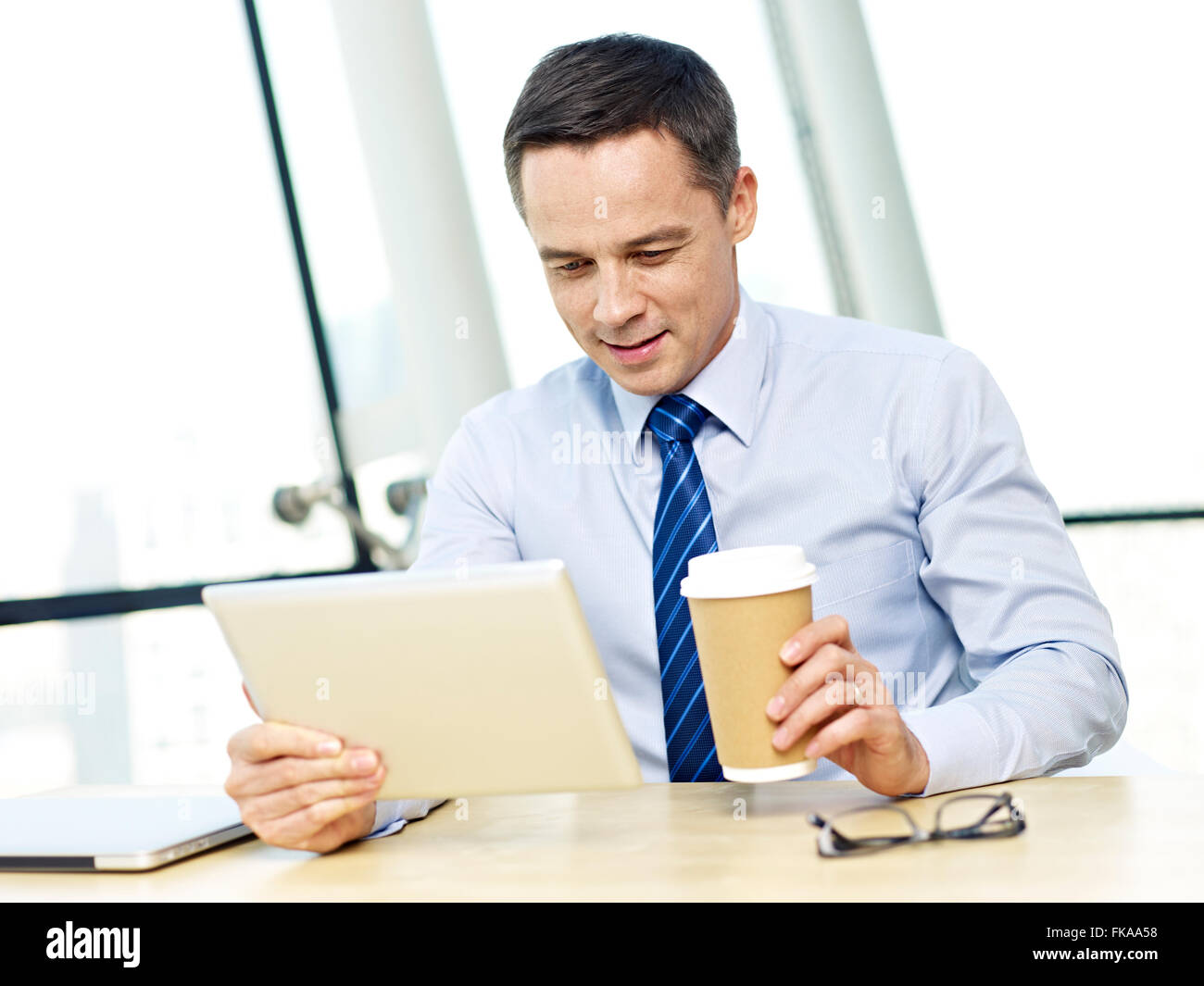 businessman working in office using ipad Stock Photo
