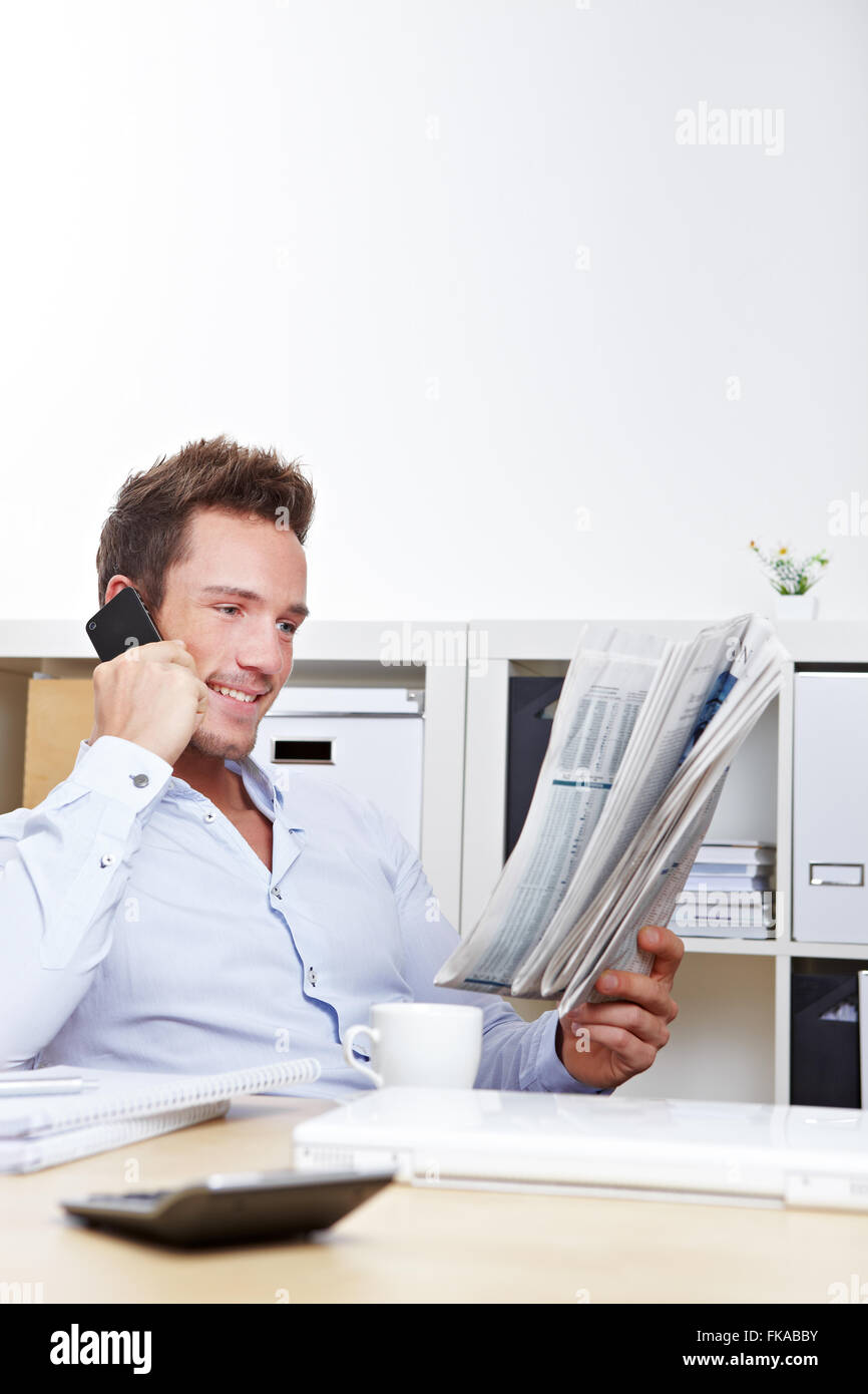 Business man on job search reading appointments section and making calls Stock Photo