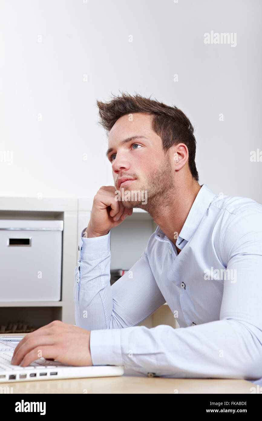 University student at laptop with writer's block whilw working on final thesis Stock Photo