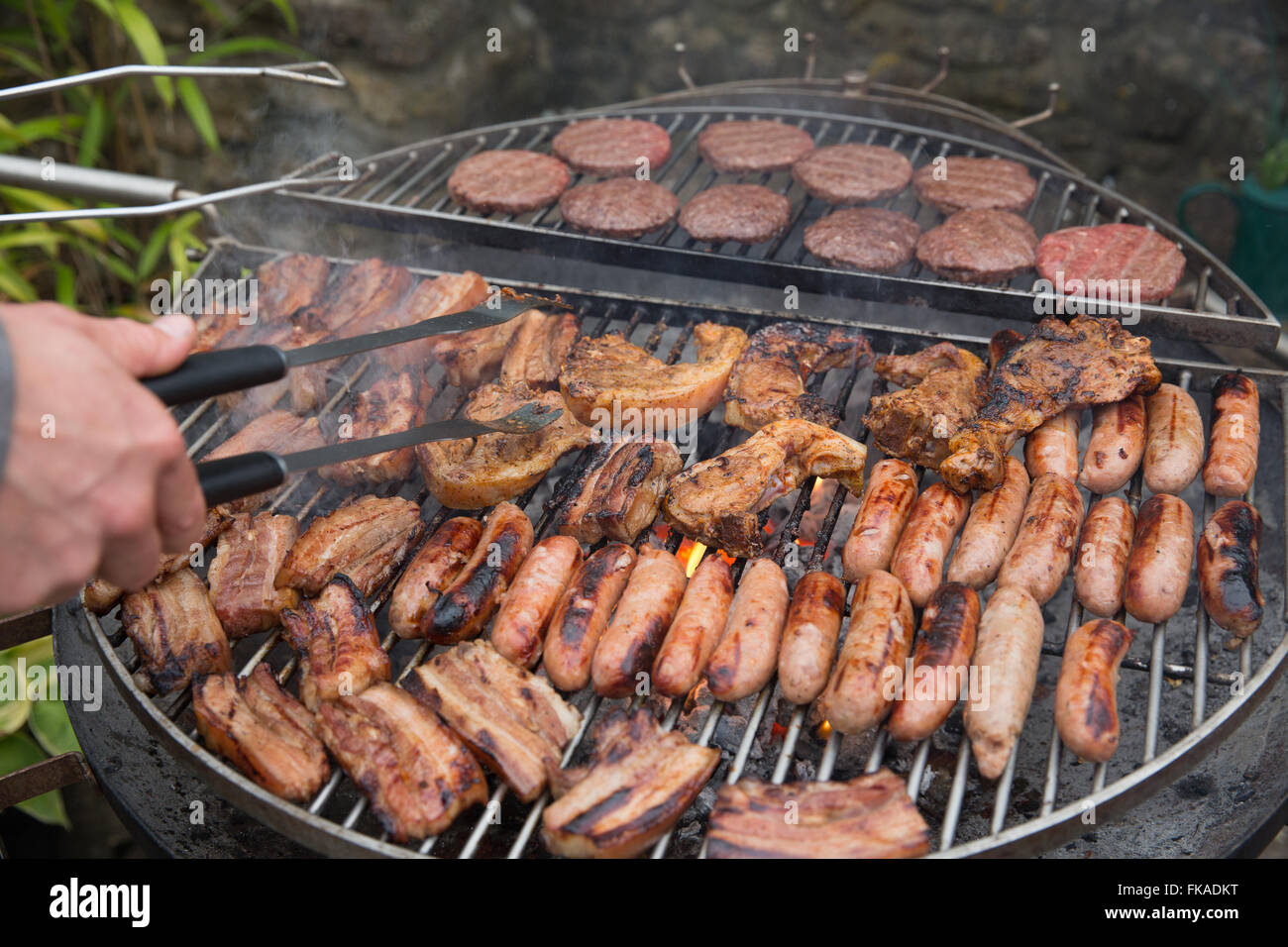 meat grilling on the barbecue, NotonFest, Milborne Port, Somerset, England, UK Stock Photo
