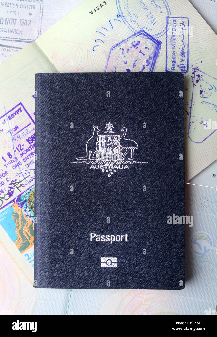 Australian passport sitting on open passports pages and visa stamps Stock Photo -