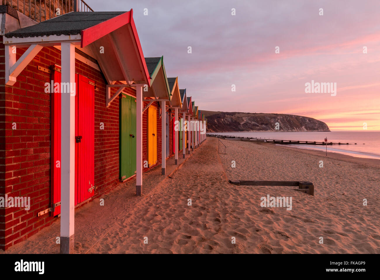 beautiful view of Swanage bay from colourful beach huts at sunrise Stock Photo