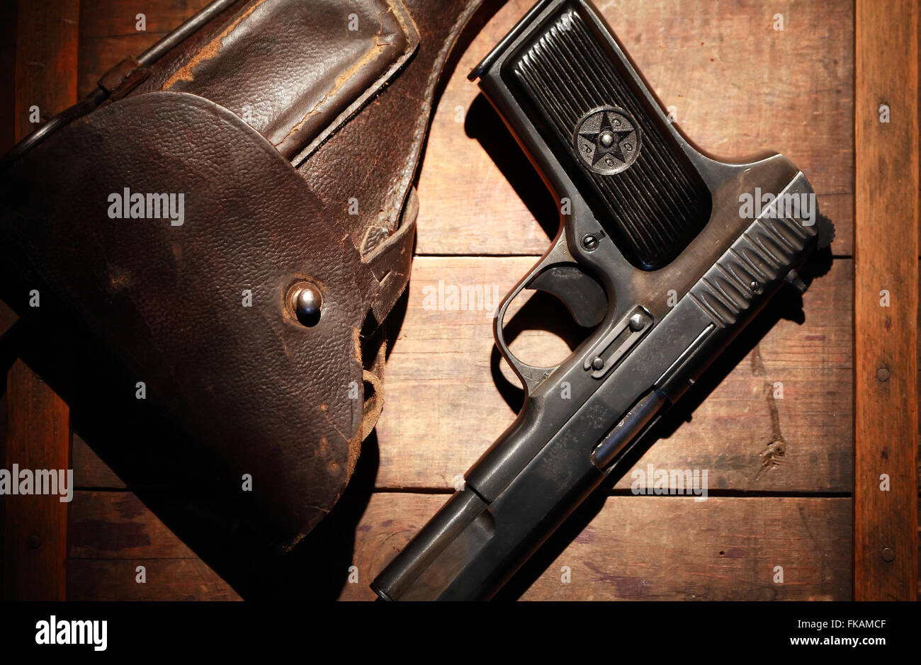 World War II Soviet equipment. Leather handgun holster and pistol on wooden board Stock Photo