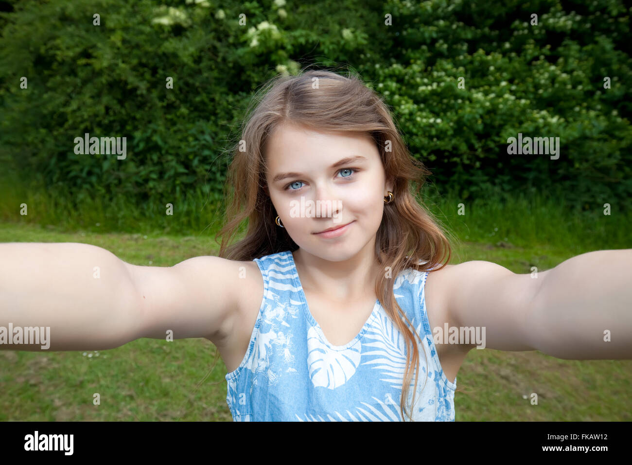 young girl making selfie photo in park Stock Photo
