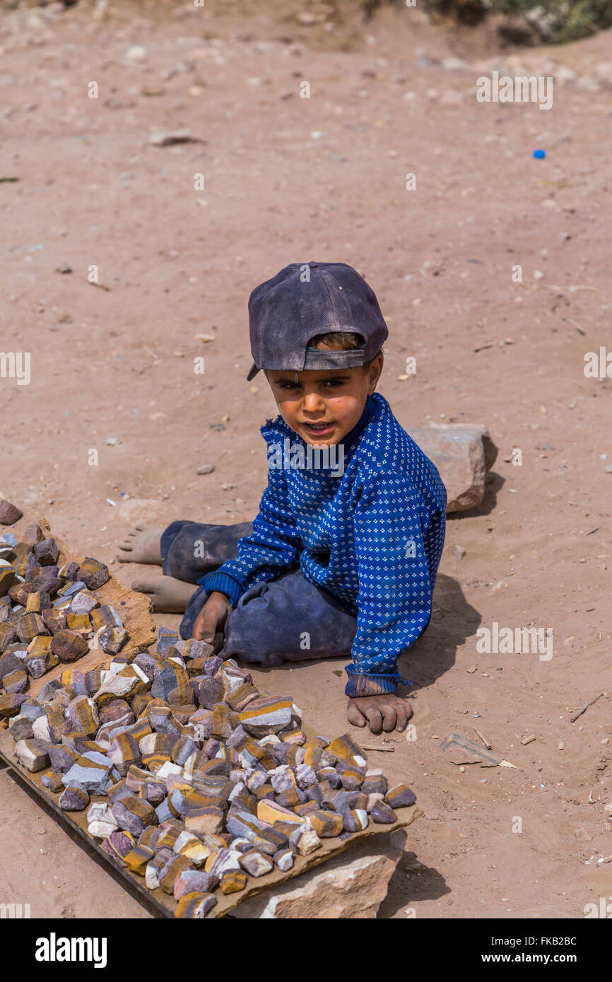 A young boy selling souvenir rocks in the ruins of Petra, Hashemite ...
