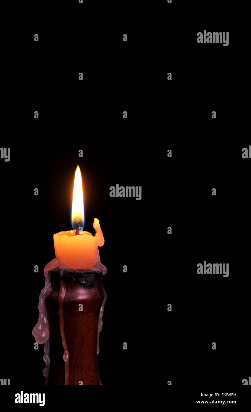 Single wax candle flame burning in darkness Stock Photo Alamy