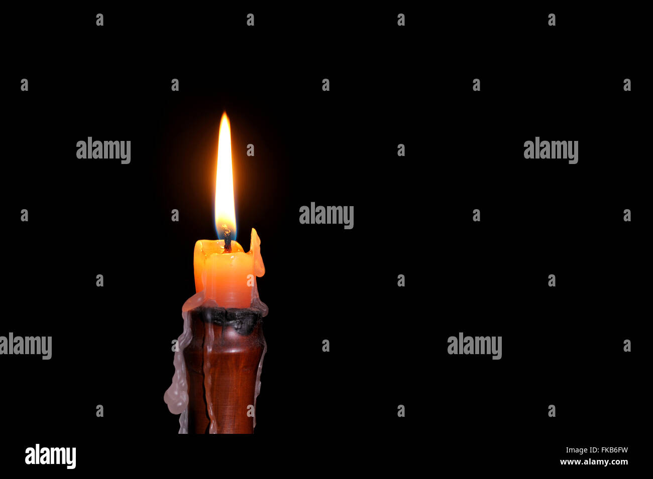 Single wax candle flame burning in darkness Stock Photo Alamy