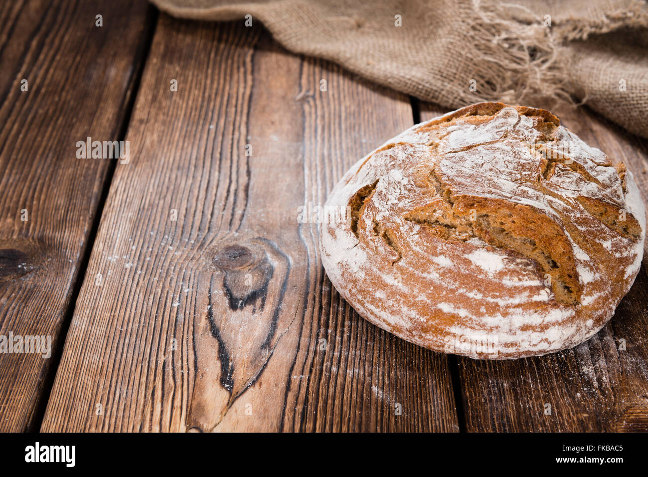 Bread on dark rustic wooden background as detailed close-up shot Stock Photo