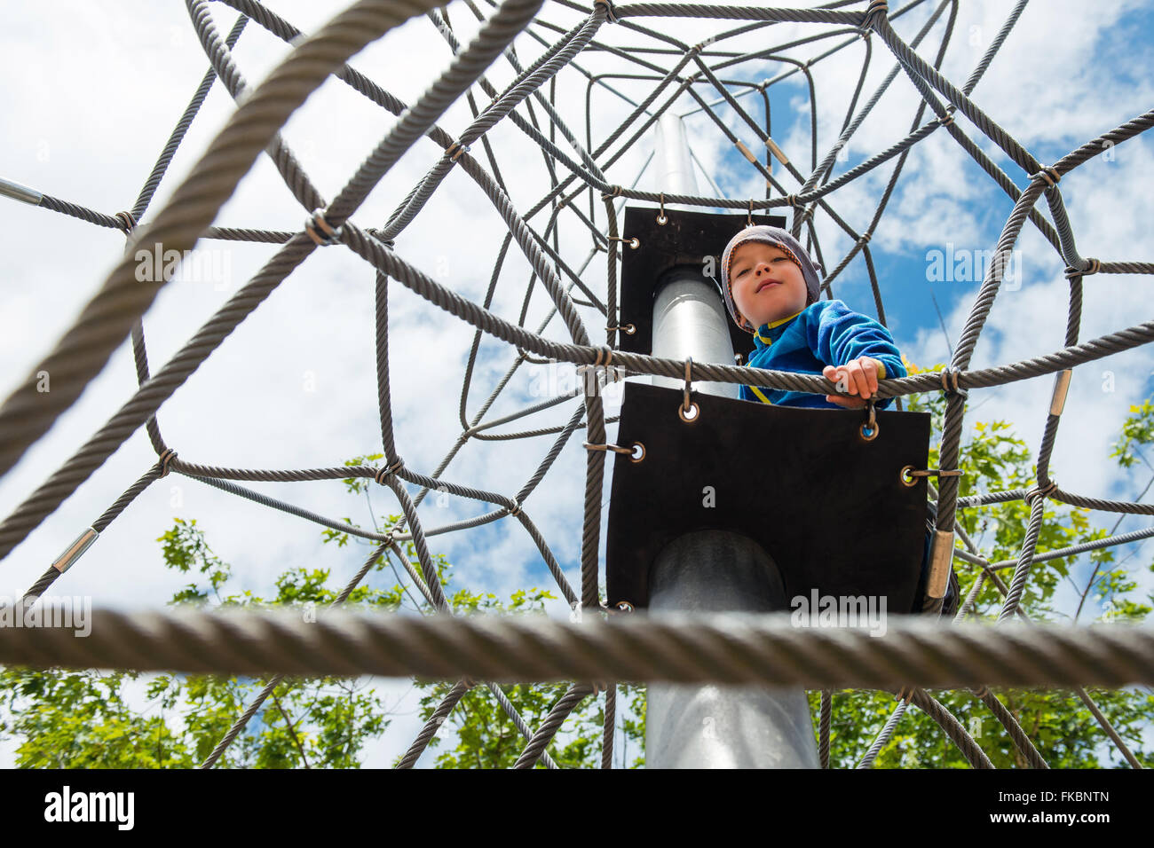 Happy young boy playing at outdoor playground Stock Photo - Alamy