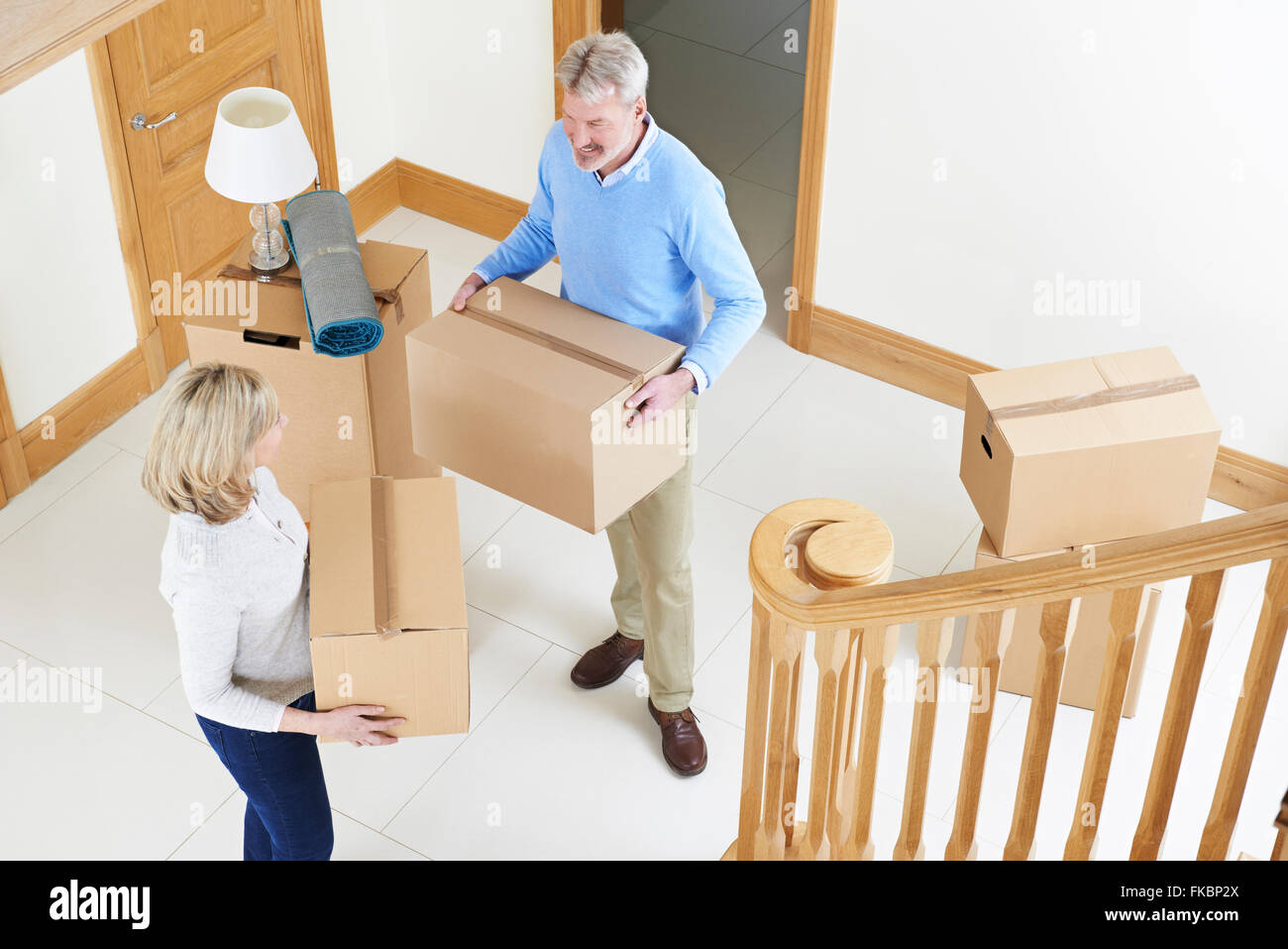 Mature Couple Moving In To New Home Stock Photo
