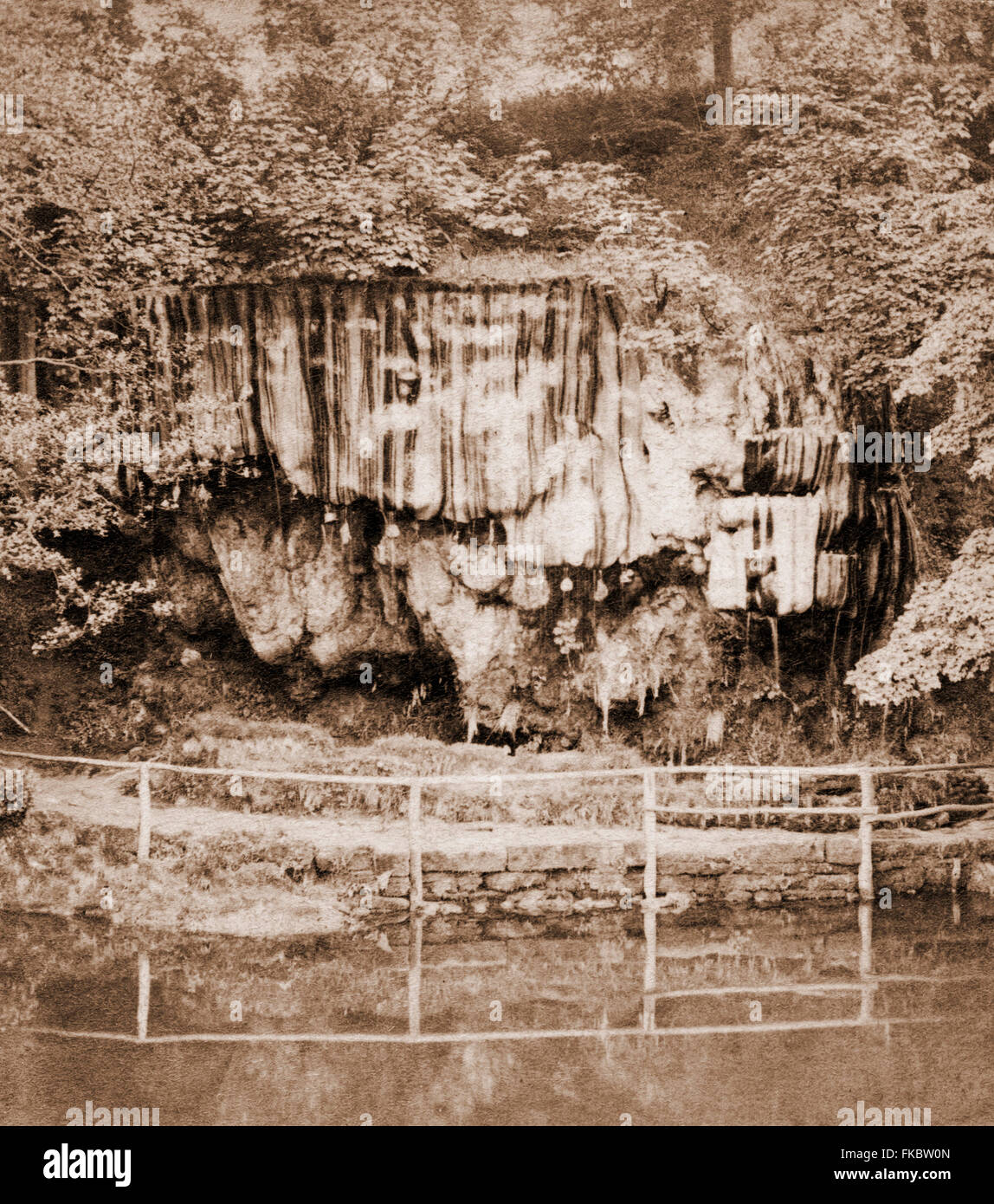 Dropping Well, Knaresborough, Yorkshire, note the objects hung up to be calcified in the highly mineralised flow of water Stock Photo