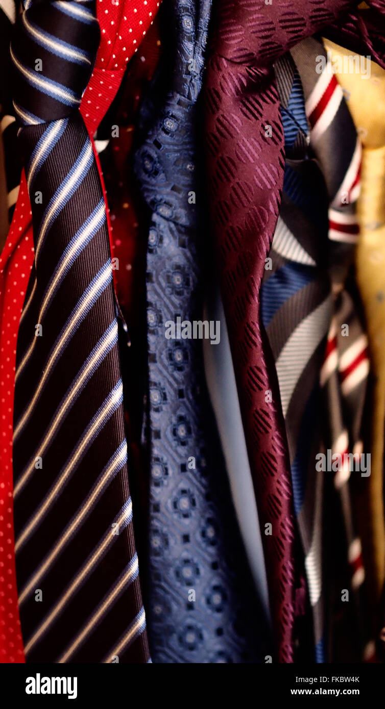 Jumble of ties hanging in a wardrobe Stock Photo