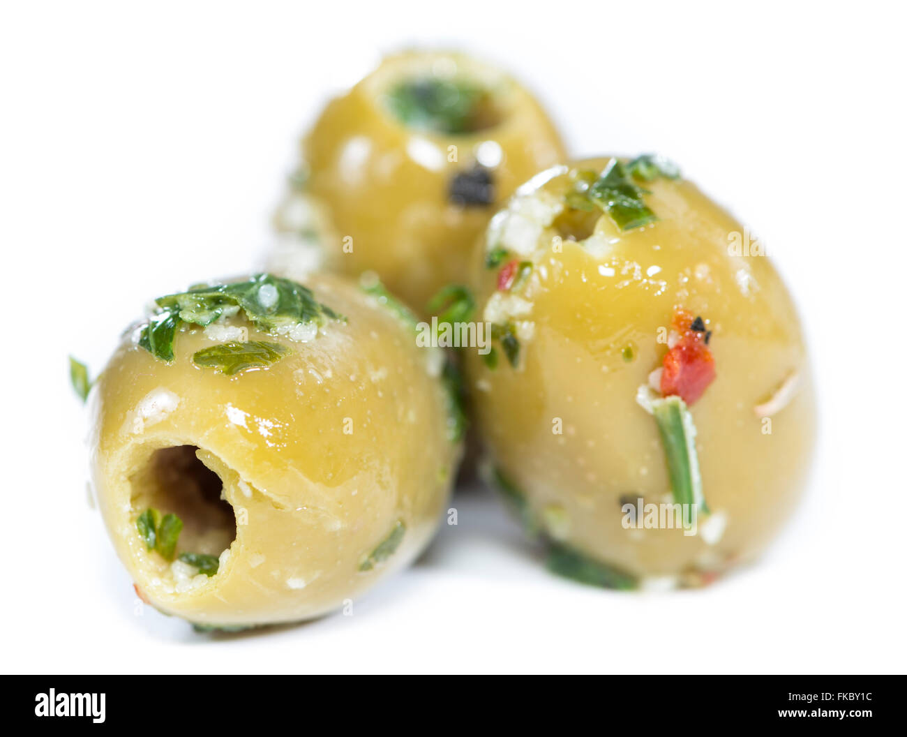 Green Olives (with garlic and herbs) isolated on white background Stock Photo