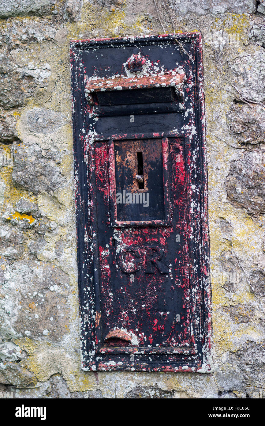 An old letterbox with snail in slot,GR,snail mail,faded, letter, letterbox, lock, mail, old, past, post, queen, red, redundant, Stock Photo