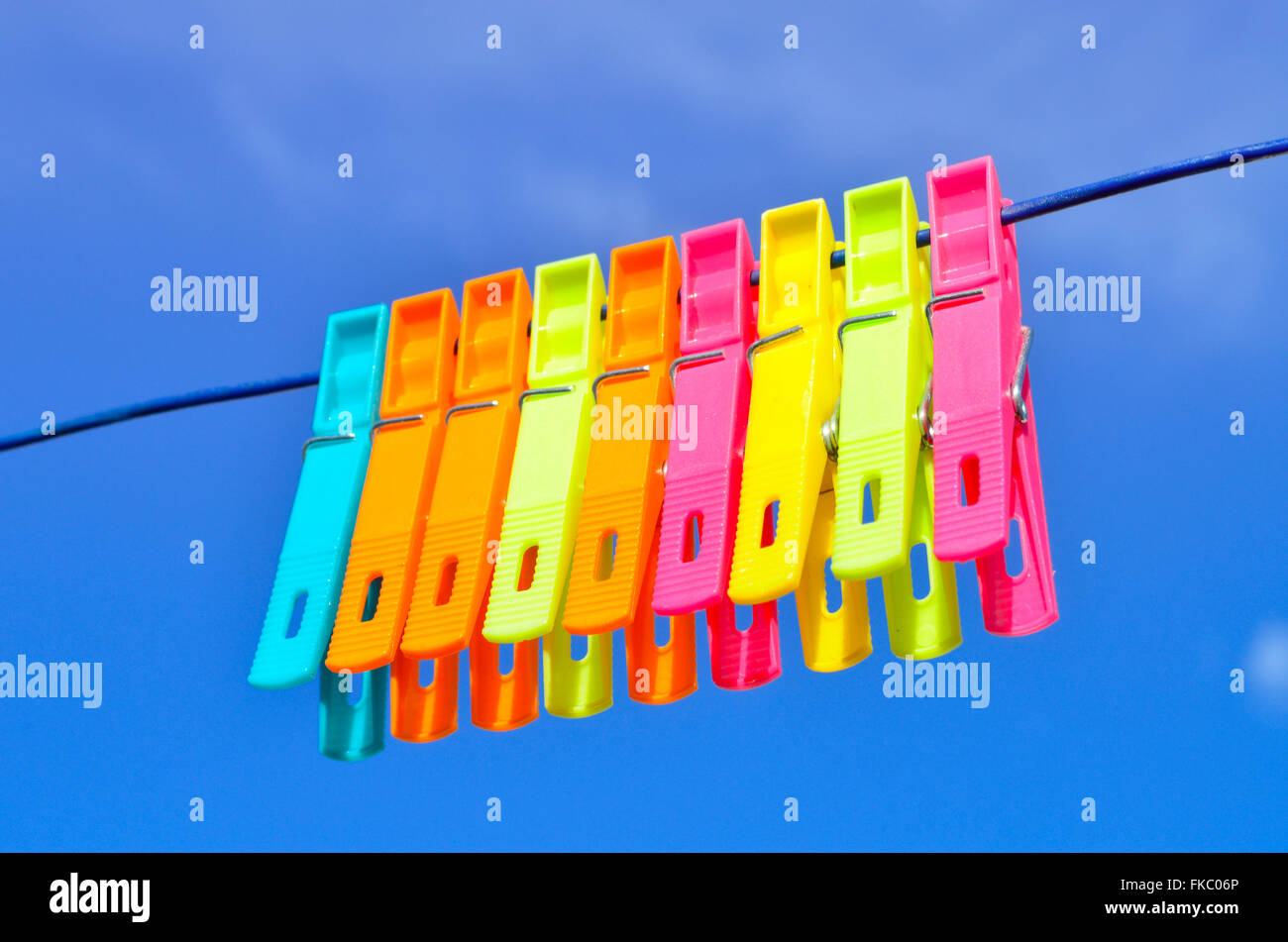 Plastic clothes pegs on washing line. Stock Photo