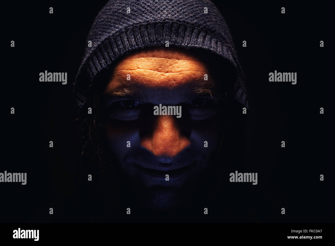 Dark figure hood facial hi-res stock photography and images - Alamy