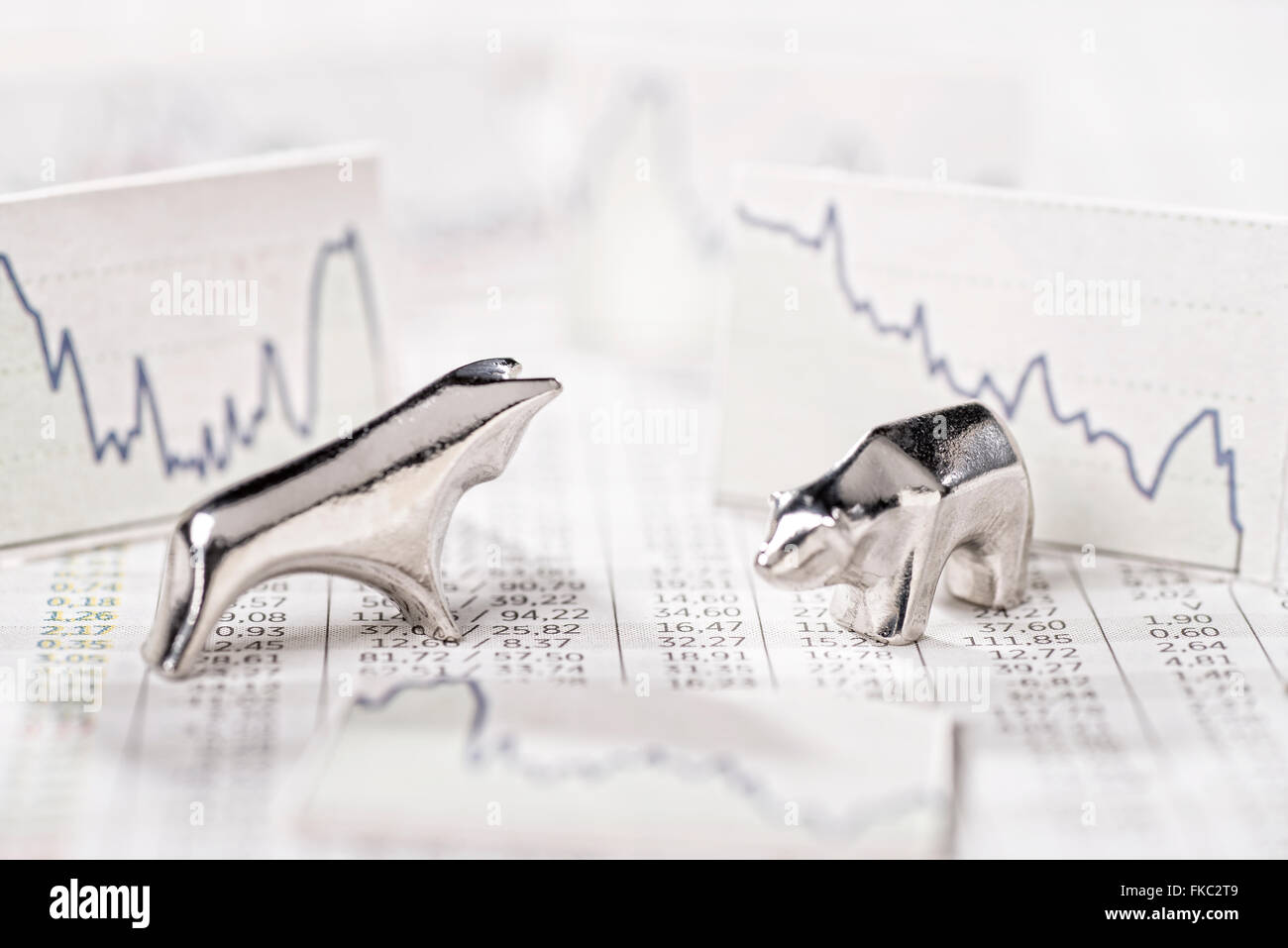 Bull and Bear and charts with descending curves. Stock Photo