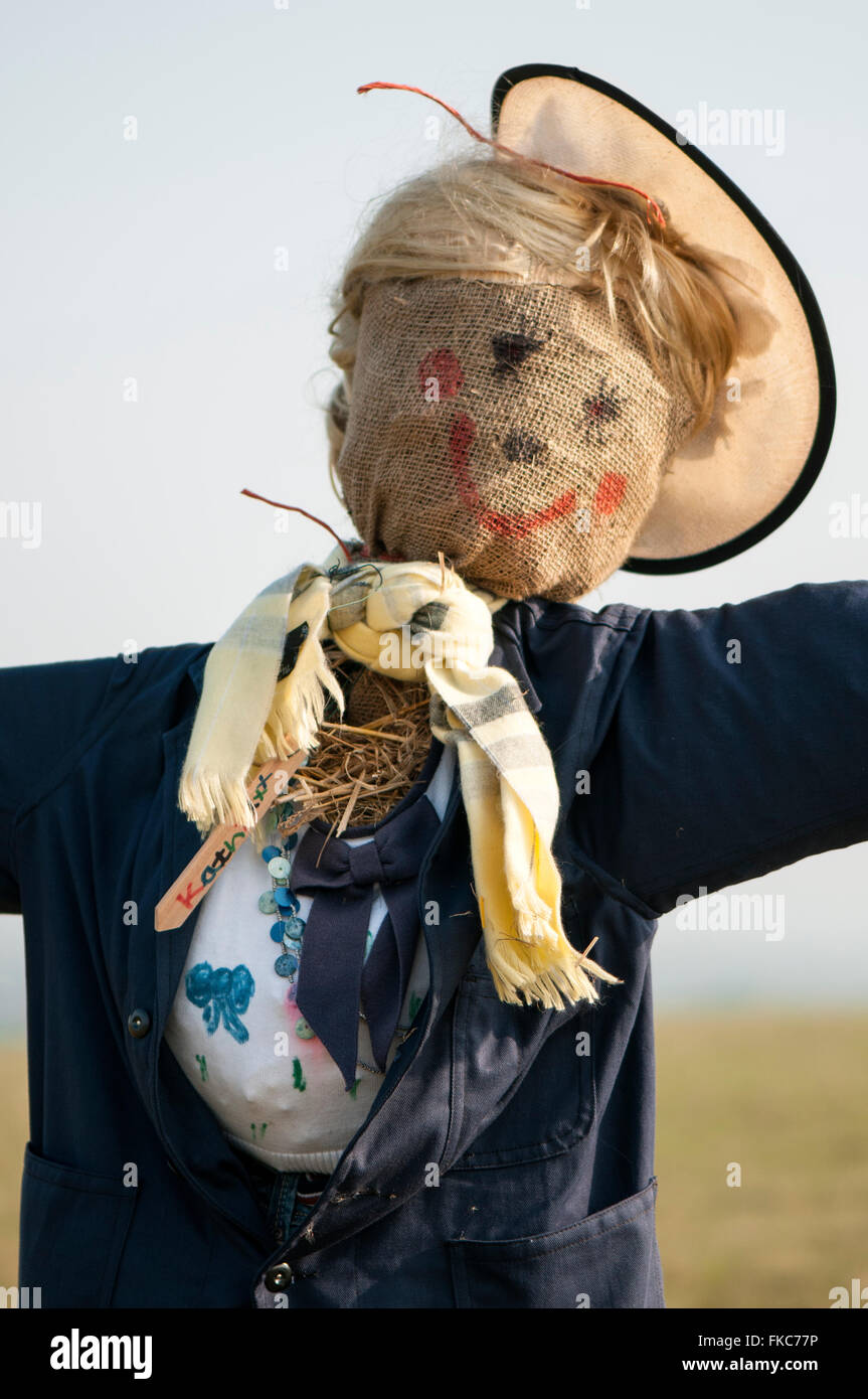 Portrait closeup image of a scarecrow stuffed with straw and wearing a hat. Stock Photo