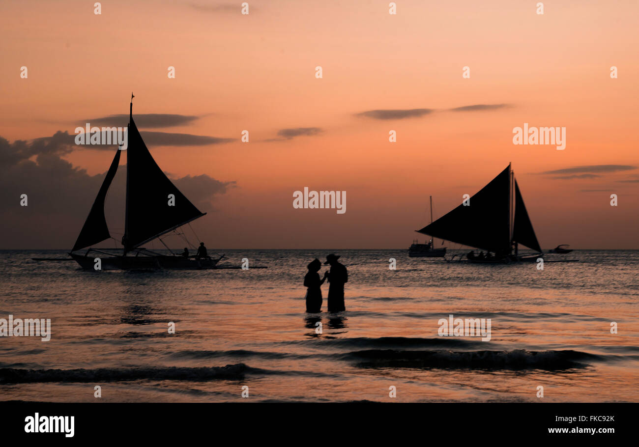 Two Boats and two peoples silhouette in the ocean Stock Photo - Alamy