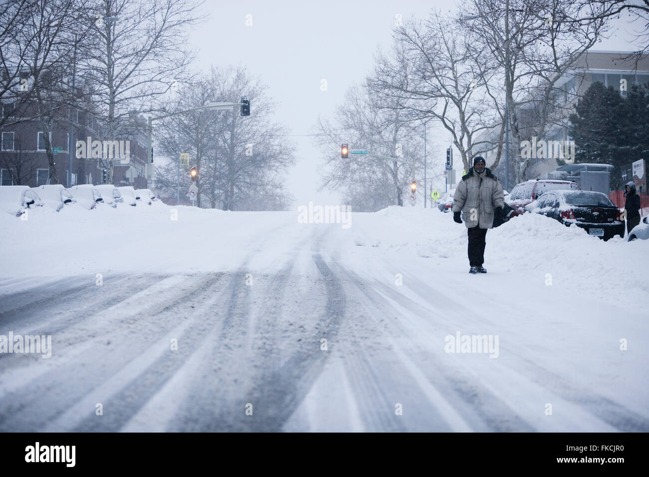 A man walking down a snowy road in Midtown Kansas City, Missouri after ...