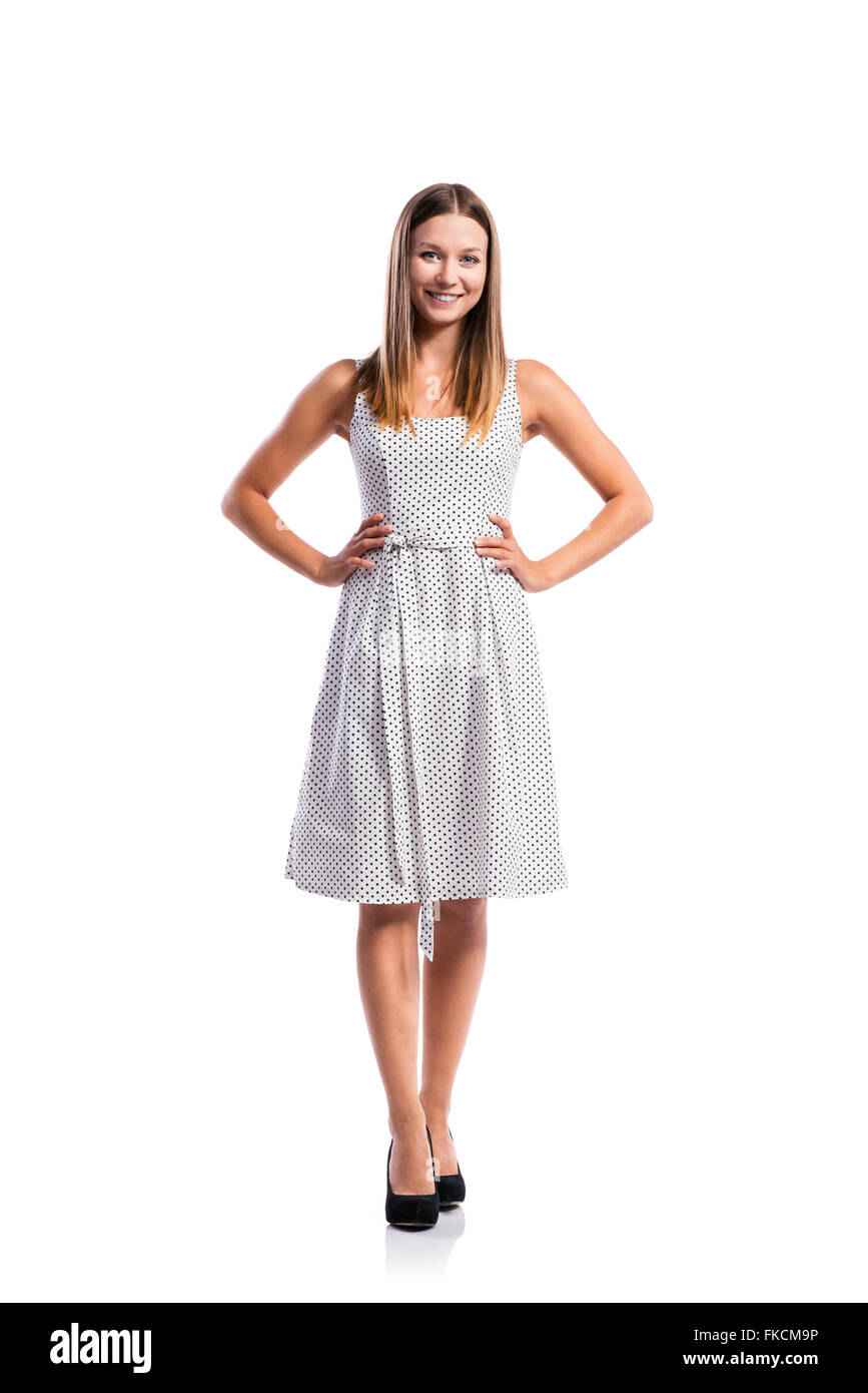 Girl in black-and-white dotted dress, heels, studio shot, isolat Stock Photo