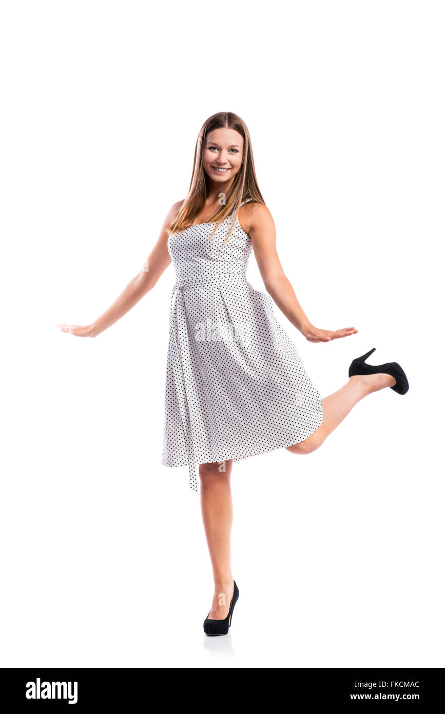 Girl in black-and-white dotted dress, heels, studio shot, isolat Stock Photo