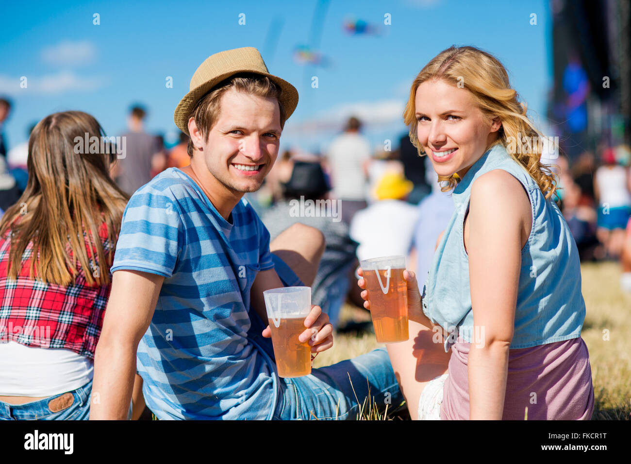 Young couple with beer at summer music festival Stock Photo