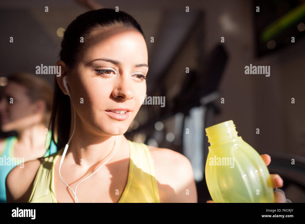 Detail, attractive woman in gym drinking water from bottle Stock Photo