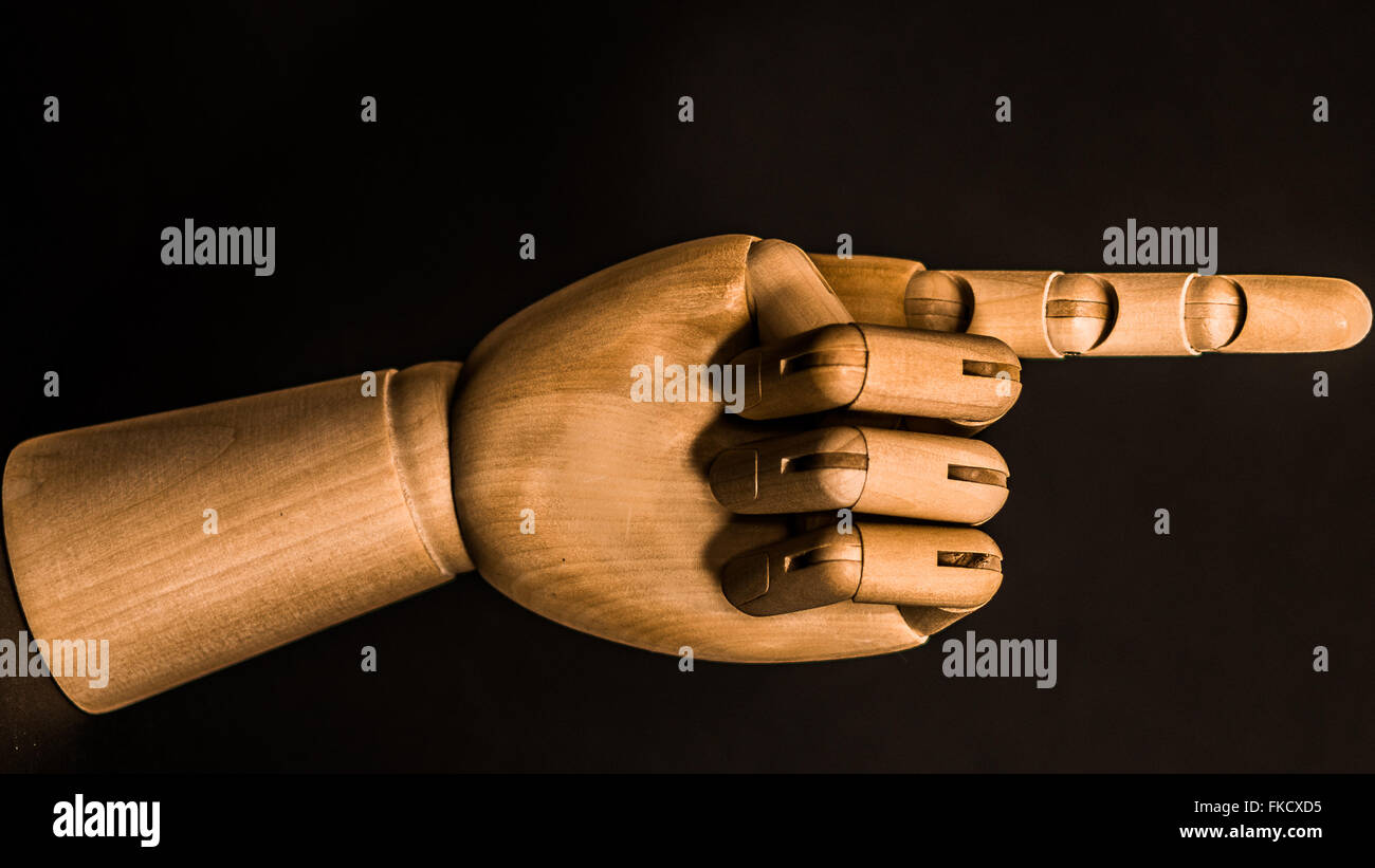 an artists mannequin hand pointing in a direction Stock Photo