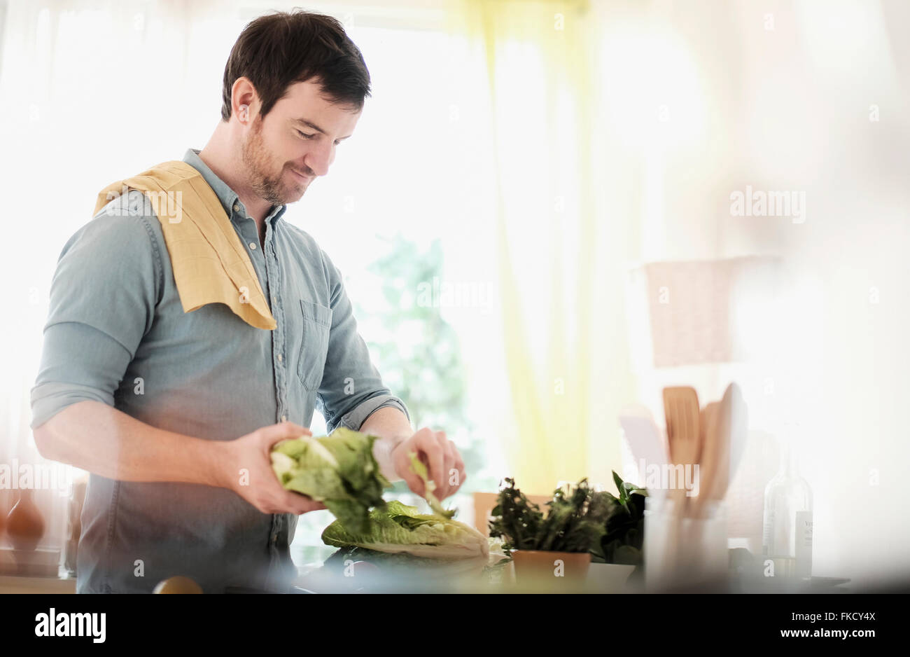 Man preparing food in kitchen Stock Photo